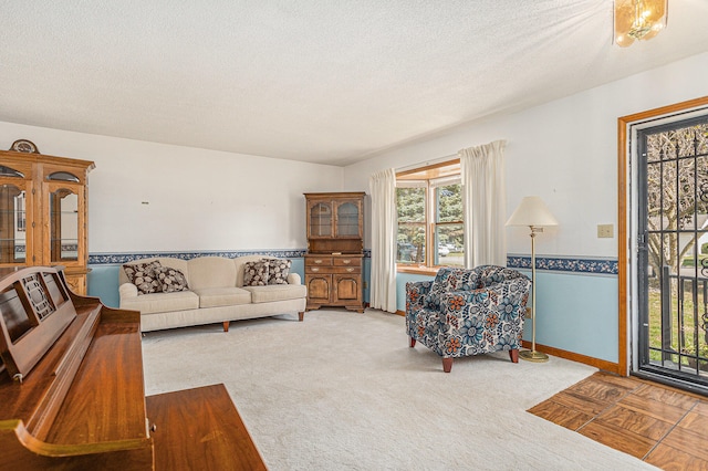 carpeted living room with a textured ceiling