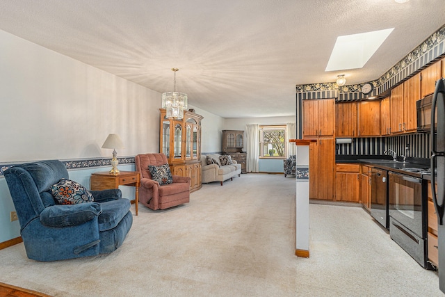 carpeted living room featuring sink, a chandelier, a textured ceiling, and a skylight