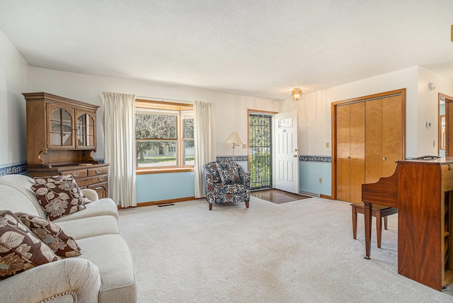 carpeted living room with a textured ceiling