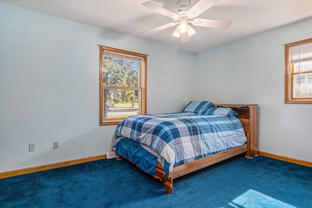 carpeted bedroom with multiple windows and ceiling fan