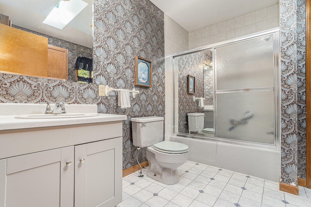 full bathroom with toilet, tile patterned flooring, vanity, combined bath / shower with glass door, and a skylight