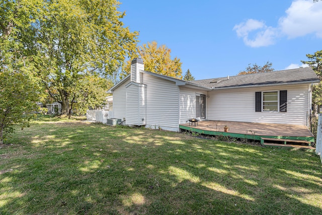 view of side of property with a yard, a wooden deck, and central air condition unit