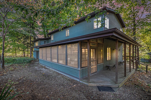 view of home's exterior with a sunroom