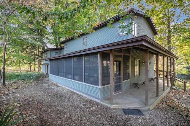 view of property exterior featuring a sunroom