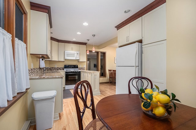 kitchen featuring light stone countertops, white appliances, light hardwood / wood-style floors, pendant lighting, and white cabinetry