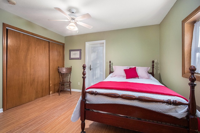 bedroom featuring ceiling fan, a closet, and light hardwood / wood-style floors