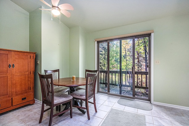 tiled dining room with lofted ceiling and ceiling fan