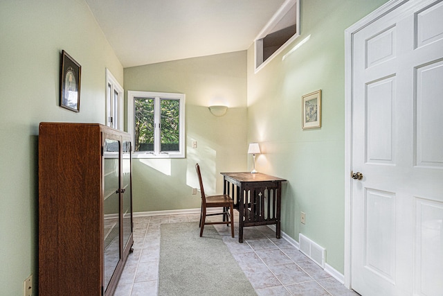 tiled home office featuring vaulted ceiling