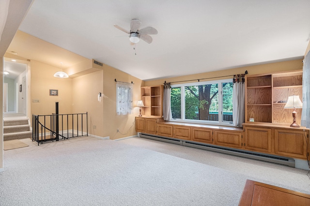 unfurnished living room with ceiling fan, vaulted ceiling, a baseboard heating unit, and light carpet