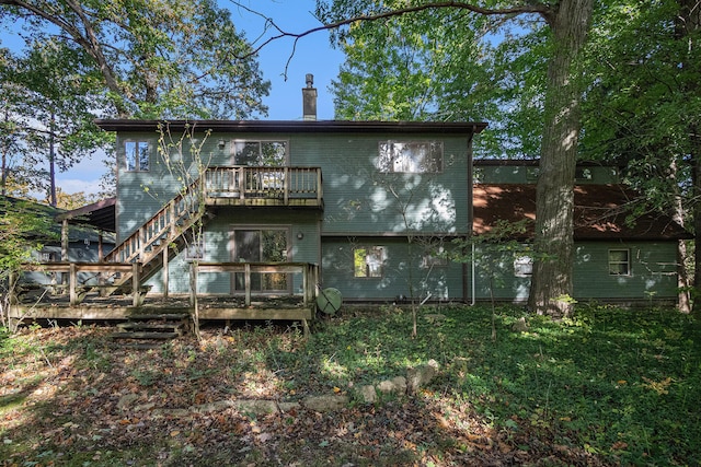 rear view of property featuring a wooden deck