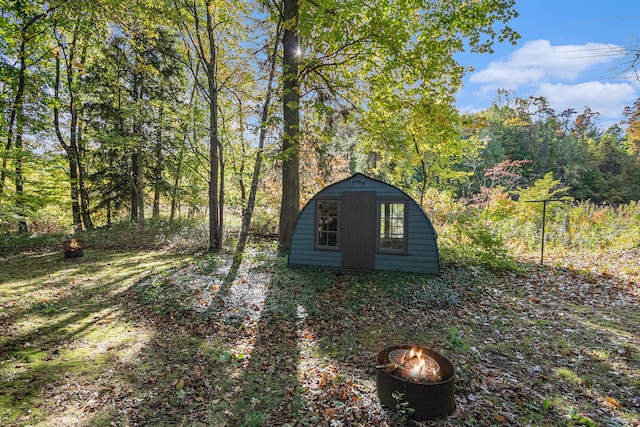 view of outbuilding featuring a fire pit