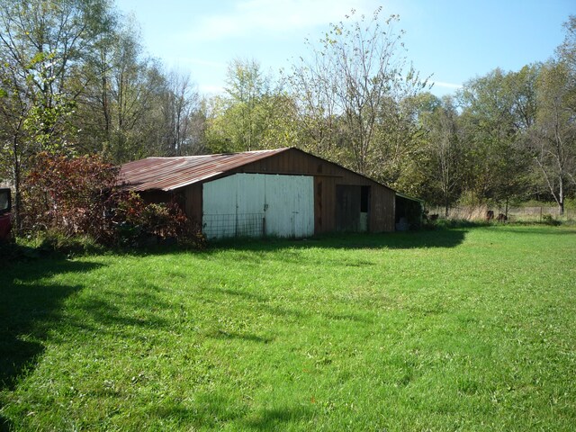 view of outbuilding featuring a yard