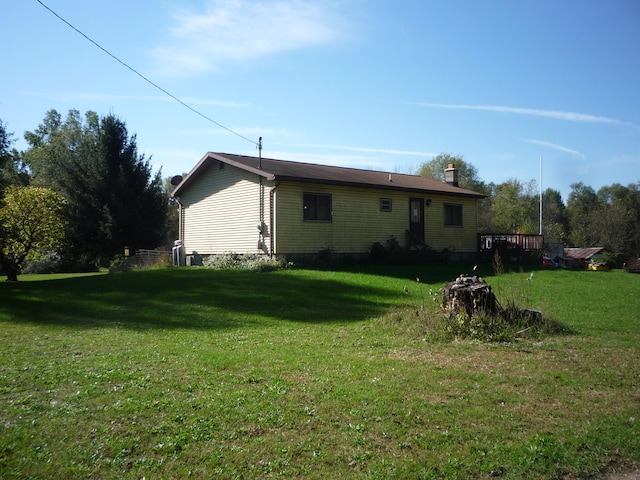 rear view of property with a lawn