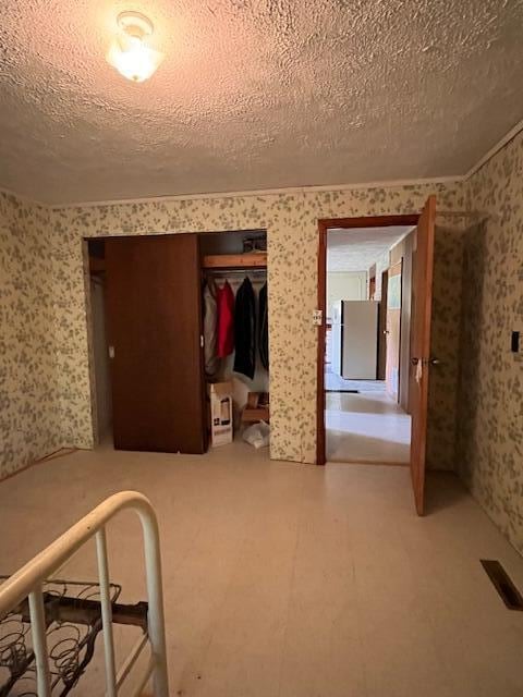 unfurnished bedroom with a textured ceiling