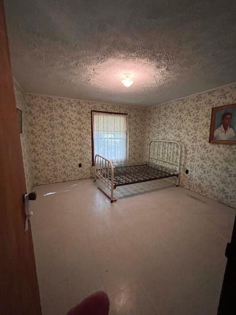 unfurnished bedroom featuring a textured ceiling