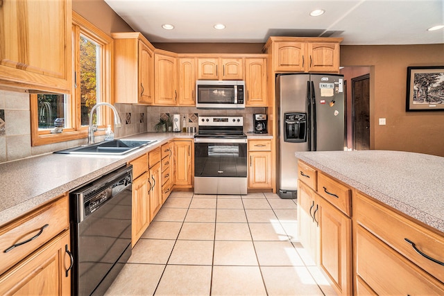 kitchen featuring light brown cabinets, tasteful backsplash, sink, appliances with stainless steel finishes, and light tile patterned floors