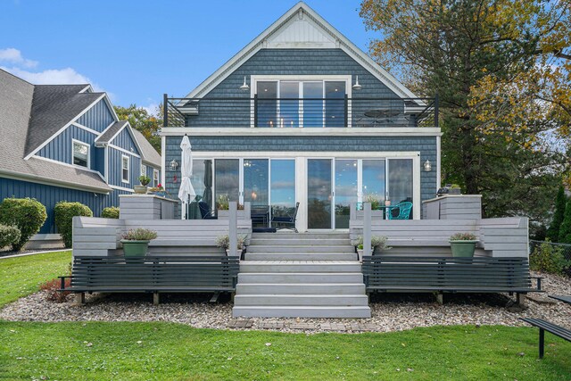 back of house with a yard and a sunroom