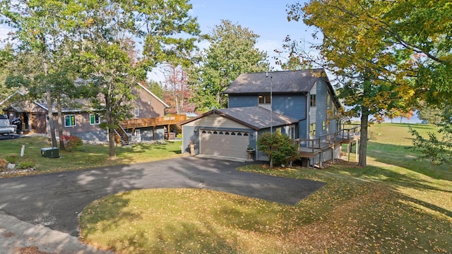 view of front of home with a garage and a front lawn