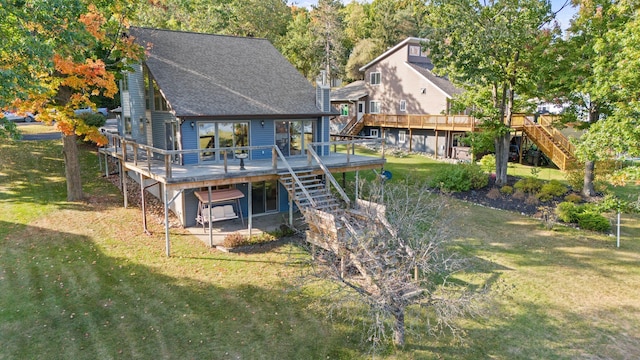 back of property with a wooden deck and a lawn