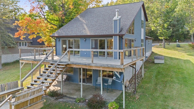 back of house featuring a deck, a lawn, and a patio