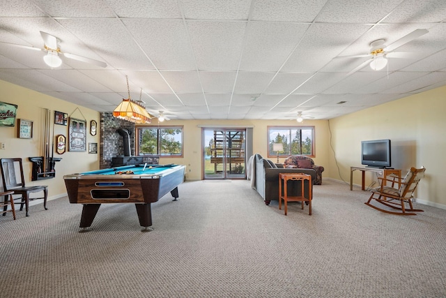 game room with carpet flooring, pool table, and a wood stove