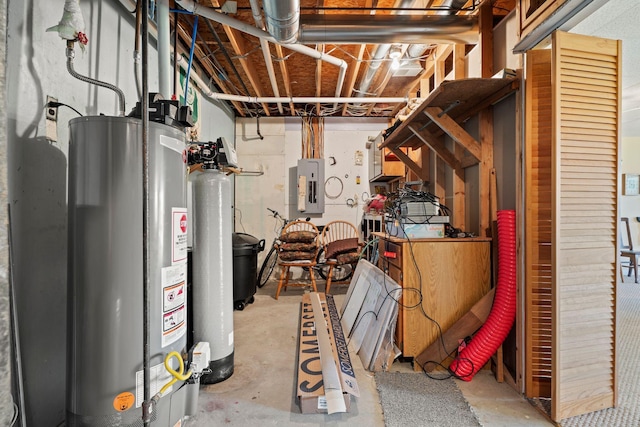 basement featuring electric panel and water heater