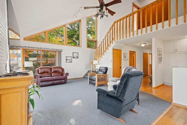 living room with high vaulted ceiling, light wood-type flooring, and ceiling fan