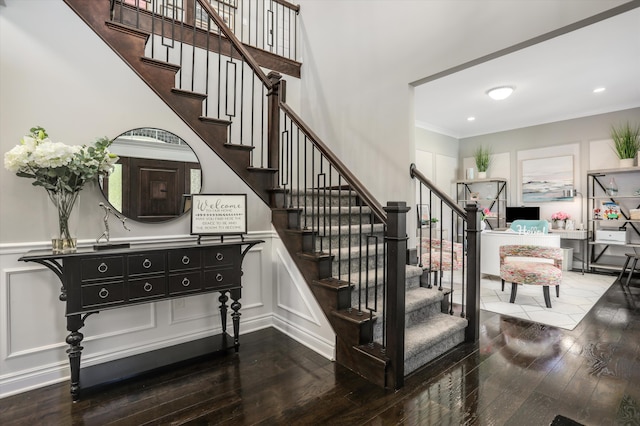 stairs featuring ornamental molding and hardwood / wood-style floors