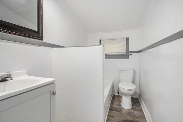 bathroom featuring vanity, ornamental molding, hardwood / wood-style flooring, and toilet