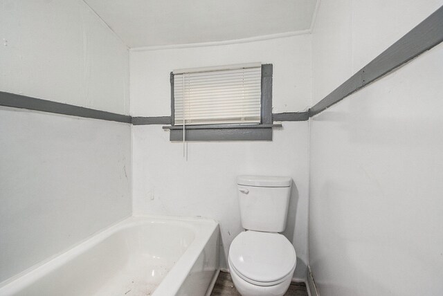 bathroom featuring toilet and a bath