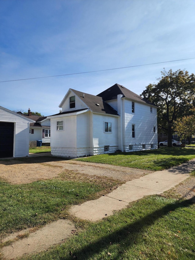 view of home's exterior with an outdoor structure, a garage, and a lawn