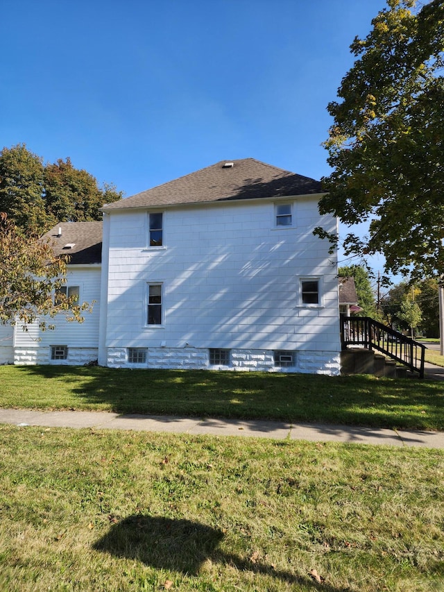 view of side of home featuring a yard