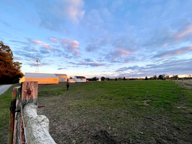 yard at dusk with a rural view