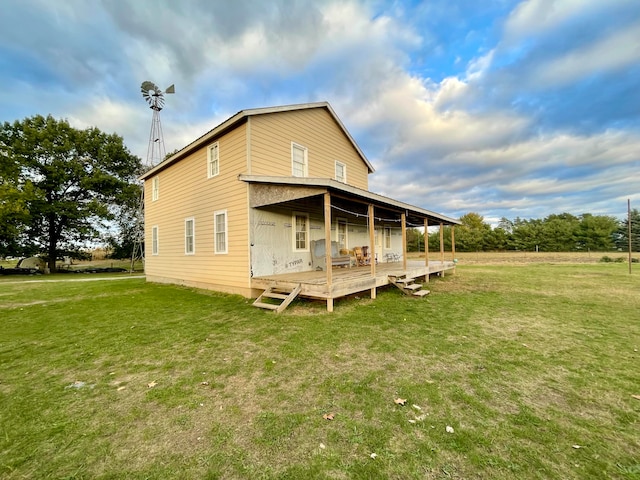 rear view of property featuring a lawn and a porch