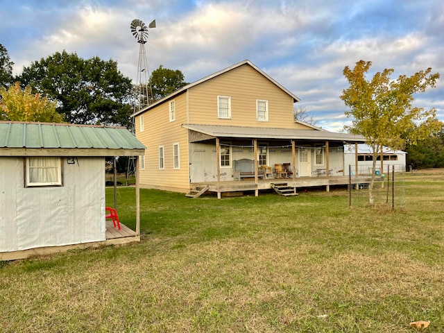 rear view of property featuring a shed and a lawn