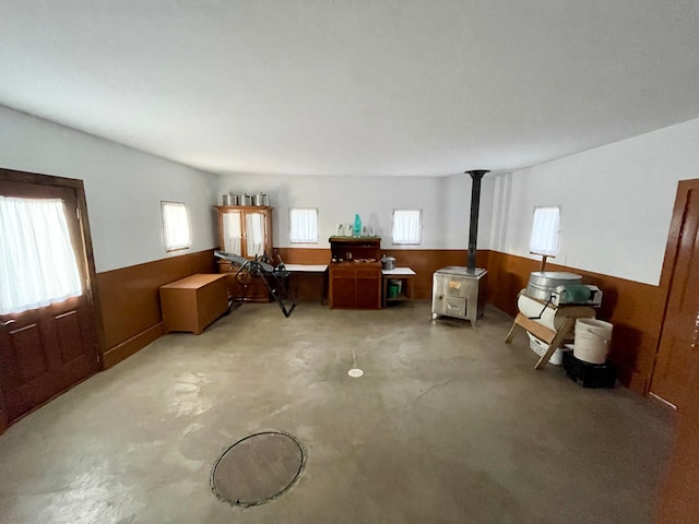 interior space with wooden walls and a wood stove