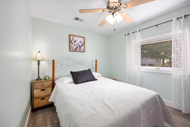 bedroom with ceiling fan and dark hardwood / wood-style flooring