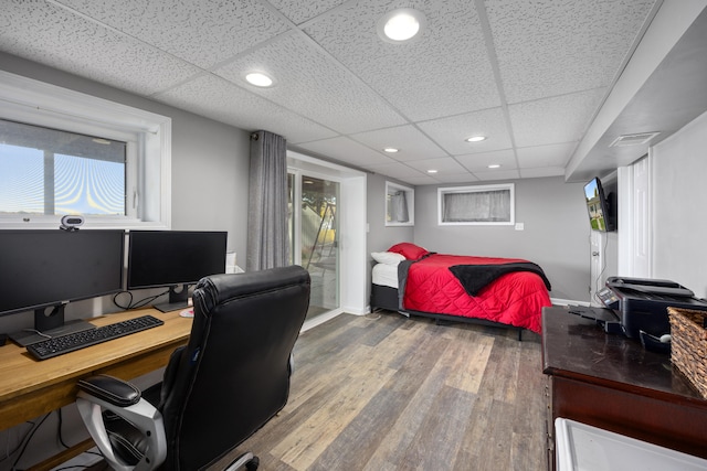 bedroom featuring a paneled ceiling and hardwood / wood-style flooring