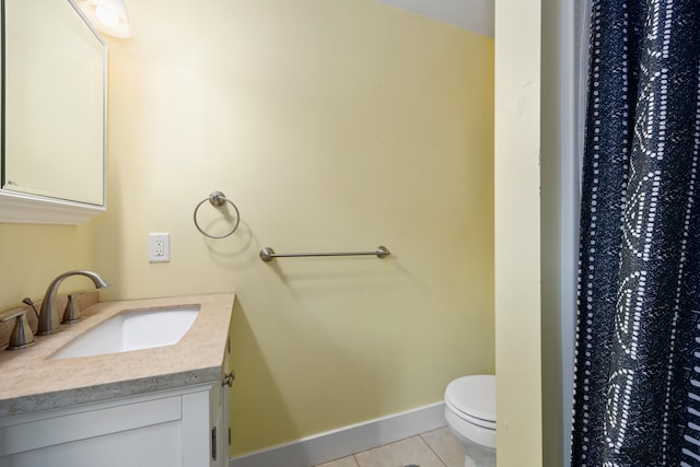 bathroom with vanity, toilet, and tile patterned floors