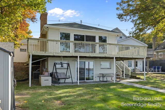 back of property with a patio, a deck, a yard, and central air condition unit