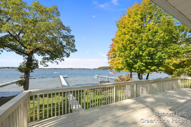 deck with a boat dock and a water view