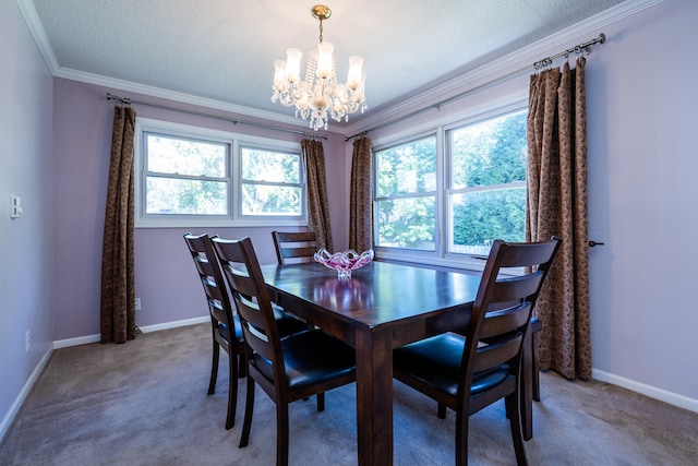 dining room featuring carpet flooring, ornamental molding, a textured ceiling, and an inviting chandelier