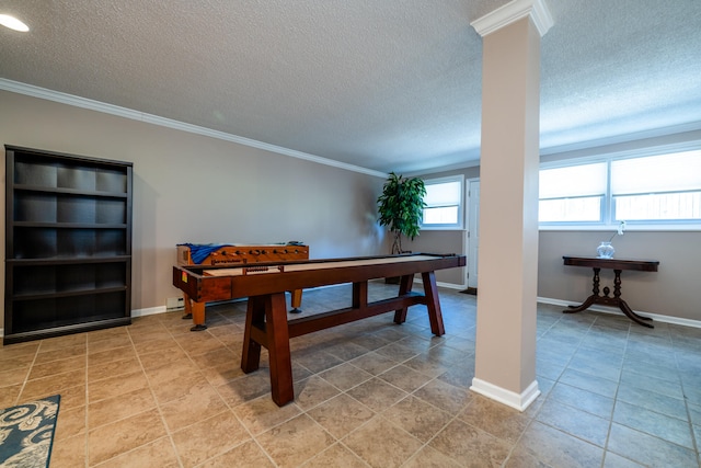 recreation room featuring crown molding, a textured ceiling, and light tile patterned floors