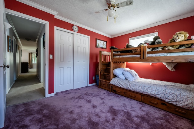 carpeted bedroom featuring crown molding, a textured ceiling, a closet, and ceiling fan