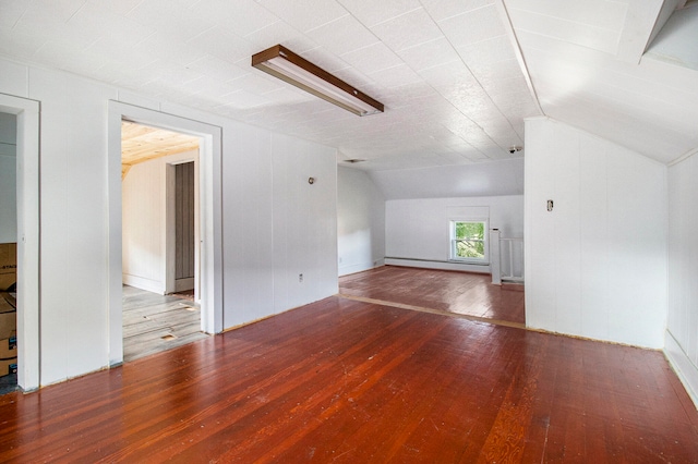 bonus room featuring wood-type flooring, a baseboard heating unit, and vaulted ceiling