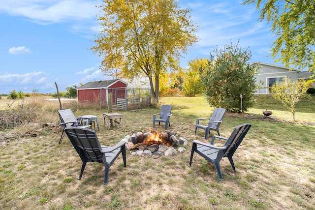 view of yard with an outdoor structure and an outdoor fire pit