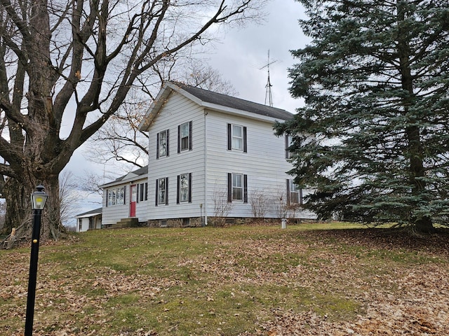 view of side of property with a yard