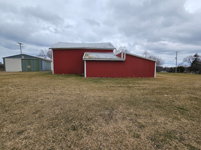 view of outbuilding with a yard