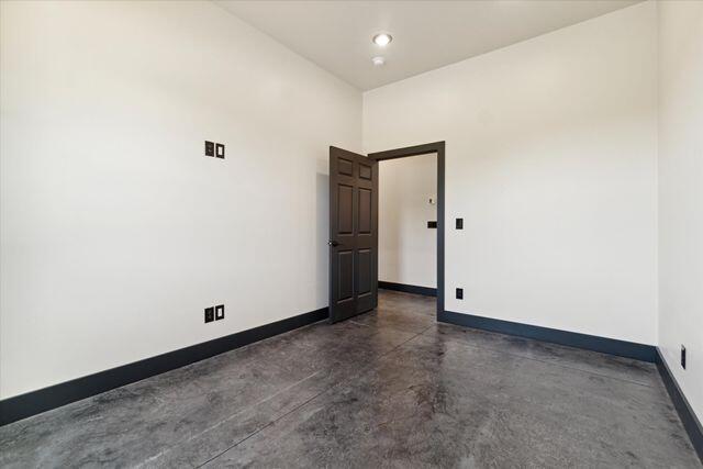 unfurnished room featuring a towering ceiling