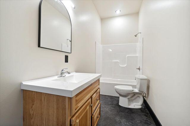 full bathroom featuring shower / tub combination, vanity, and toilet